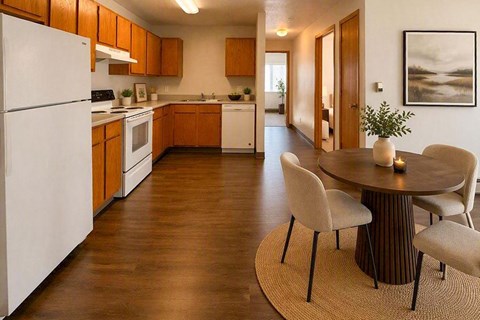 A kitchen with a white refrigerator and wooden cabinets.