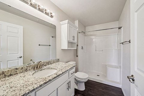 A bathroom with a sink, toilet, and bathtub.