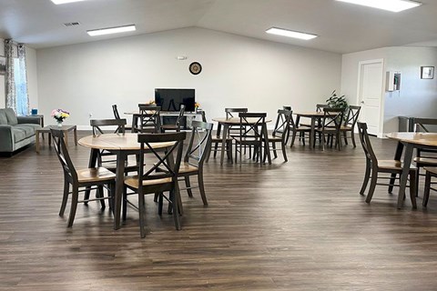 A living room with a TV, couch, and dining table.