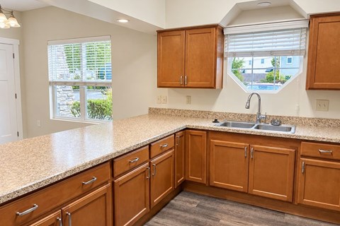 A kitchen with wooden cabinets and a granite countertop.