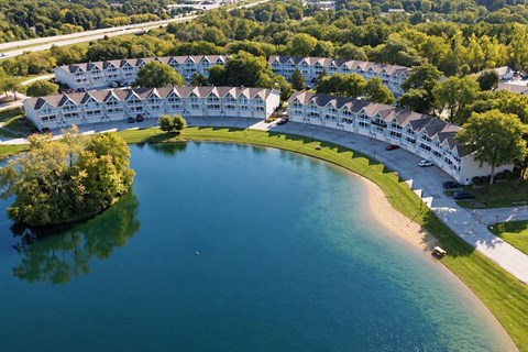 A large body of water surrounded by apartment buildings.