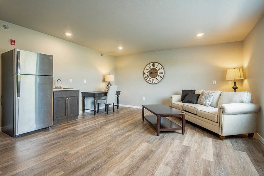 a living room with a couch and a refrigerator