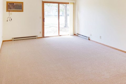 an empty living room with a sliding glass door