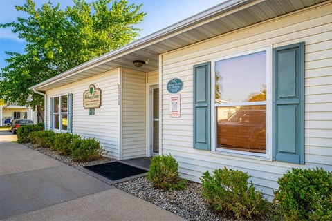 A small building with a sign on the front door.