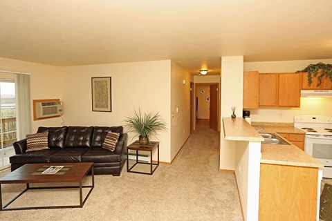 A living room with a brown leather couch and a coffee table.