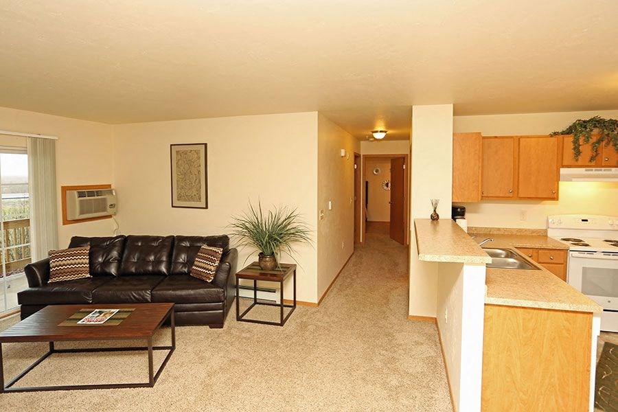 A living room with a brown leather couch and a coffee table.