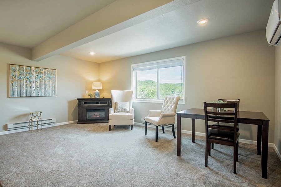 an empty living room with a table and chairs