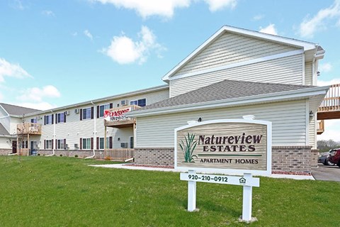 a white building with a sign in front of it