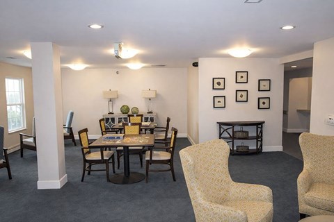 A dining room with a table set for six.