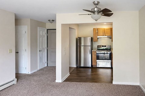 A kitchen with a refrigerator, oven, and microwave.