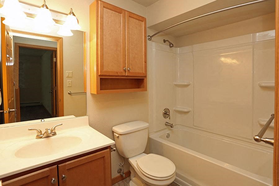 a bathroom with a sink toilet and a bath tub