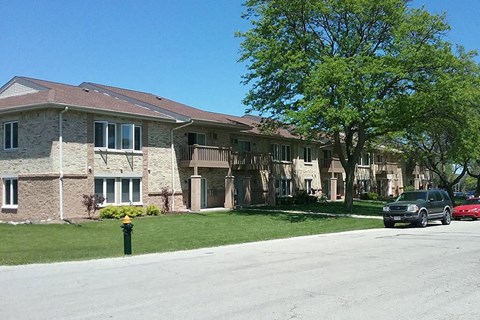 a car is parked in front of an apartment building