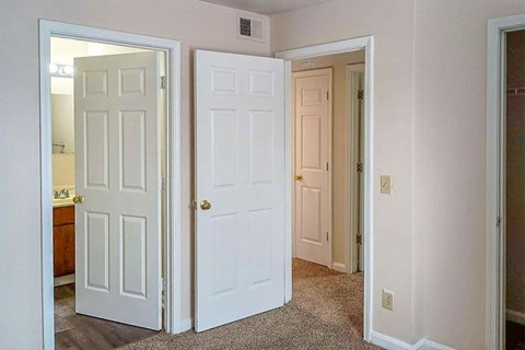 A white door is open to a hallway.