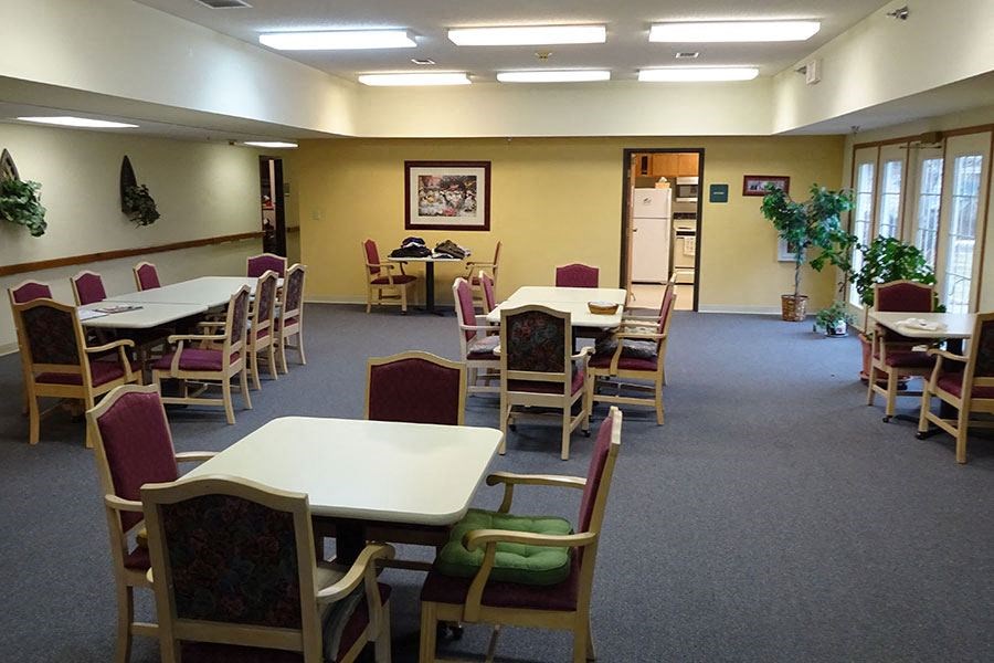 a dining room with tables and chairs and chairs