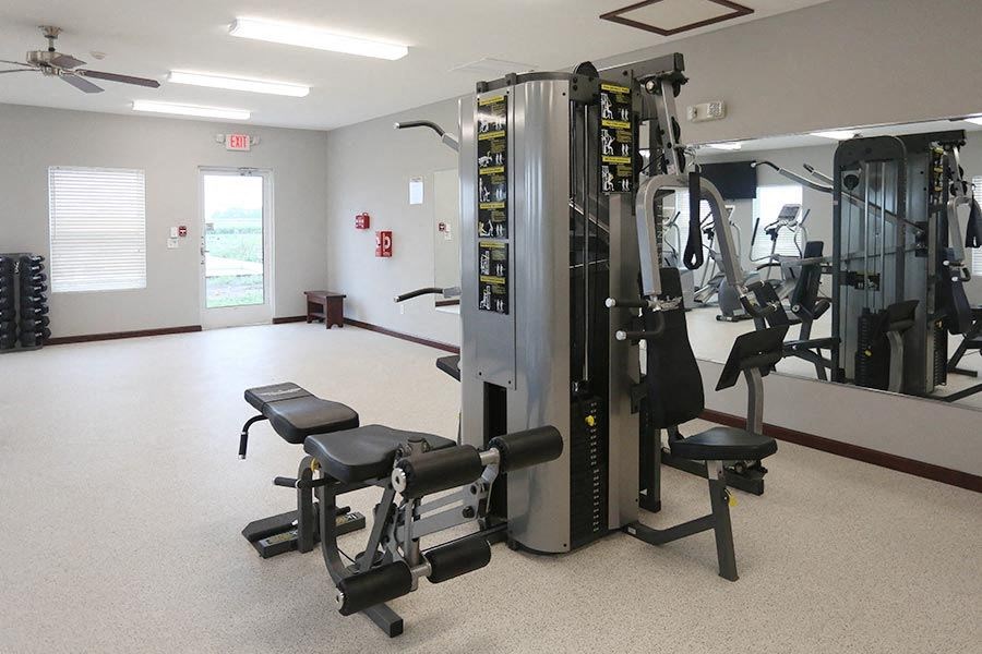 a gym with a lot of exercise equipment in it