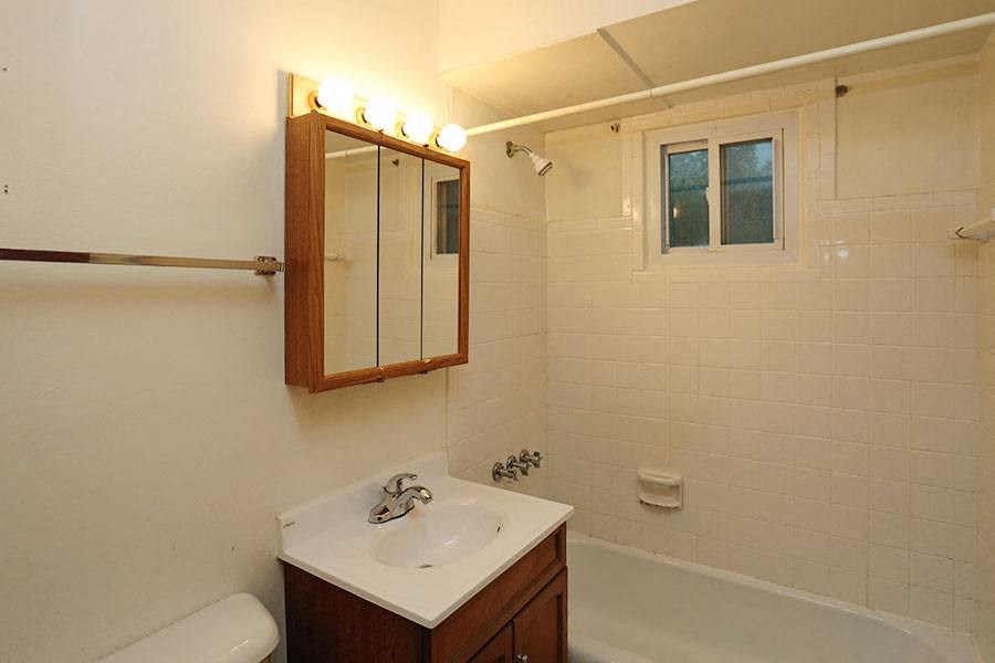 a bathroom with a sink and a mirror and a tub