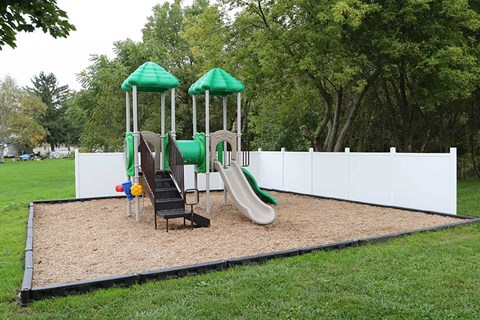 a playground with a swing set and slides