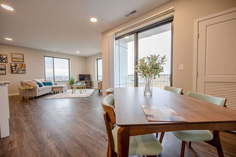 A dining room with a wooden table and chairs.