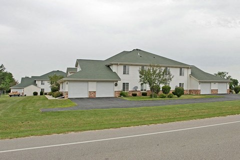 a large white house with a street in front of it