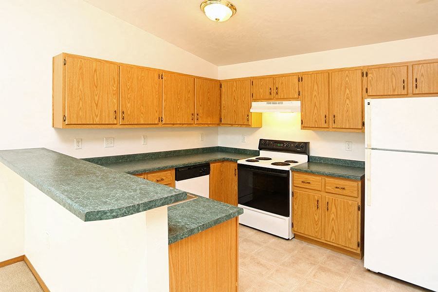 a kitchen with a stove and a refrigerator
