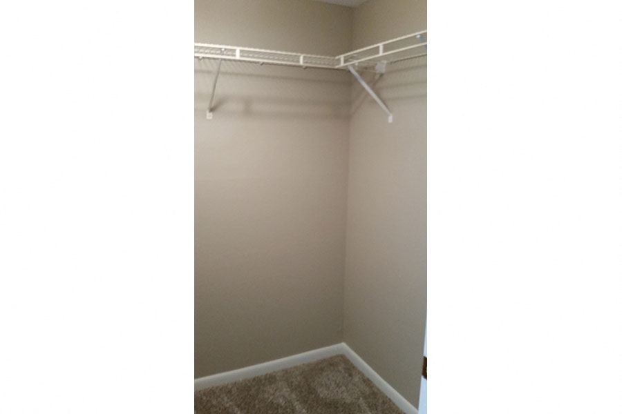 the closet in the master bedroom of the apartments