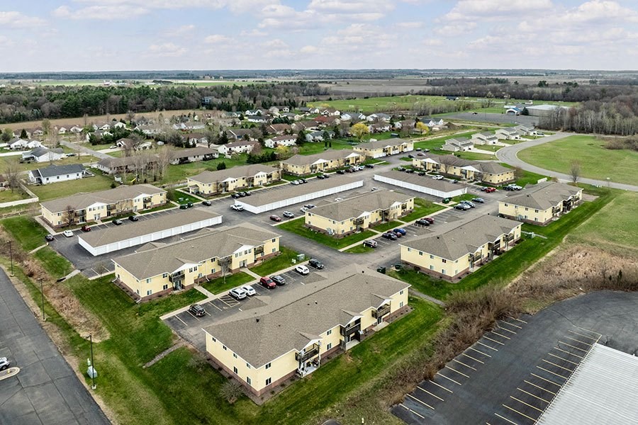 an aerial view of a neighborhood of houses and parking lot