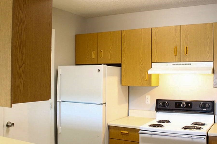 A kitchen with a white refrigerator and a white stove.