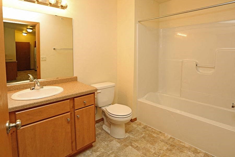 a bathroom with a sink toilet and a bath tub