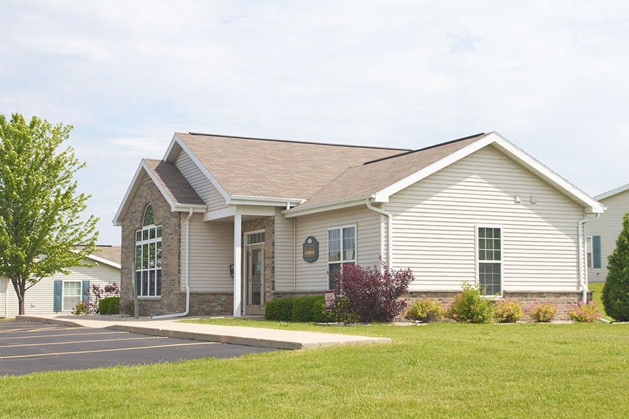 a white house with a driveway and a lawn