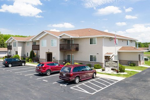 a large house with cars parked in front of it