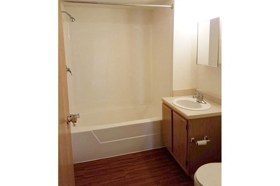 A bathroom with a toilet, sink, and bathtub.