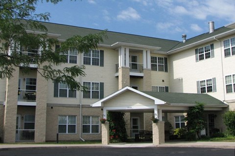A large apartment complex with a covered walkway.