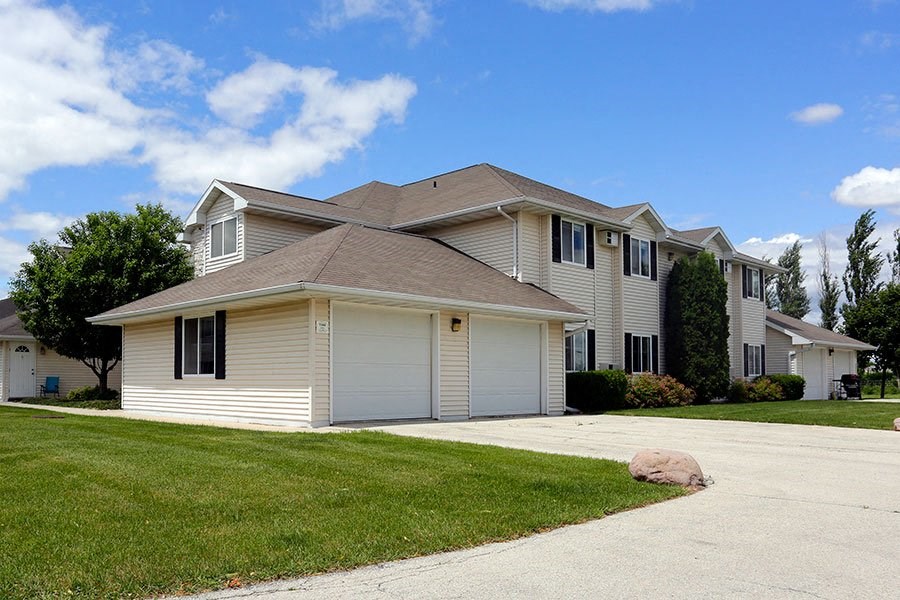 A house with a garage and a driveway in front.
