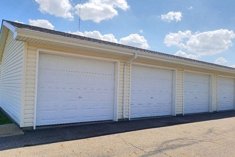 A row of white garage doors are closed.