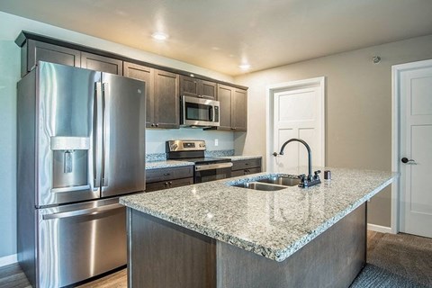 a kitchen with stainless steel appliances and a granite counter top
