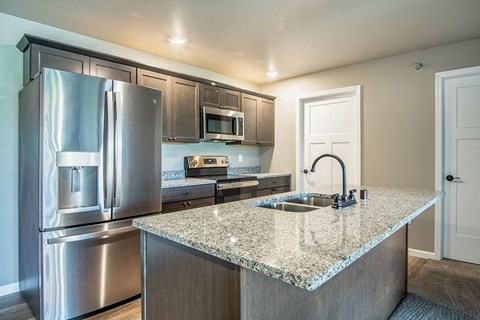 a kitchen with stainless steel appliances and a granite counter top