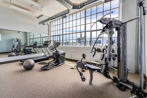A gym with a variety of equipment including a leg press machine.