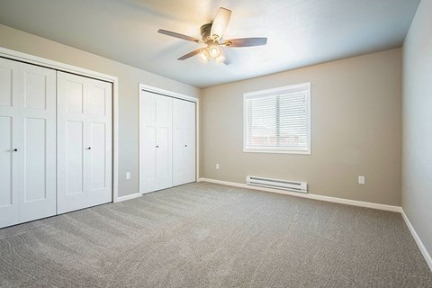 an empty room with a ceiling fan