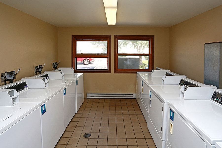 A laundromat with rows of washers and dryers.