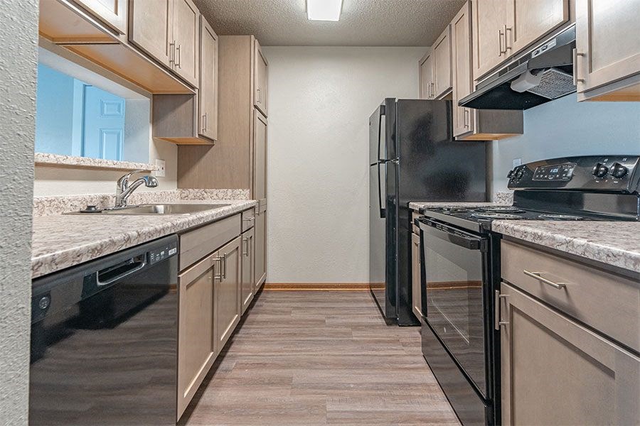 a kitchen with stainless steel appliances and marble counter tops