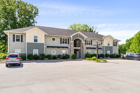 A large building with a parking lot in front of it.