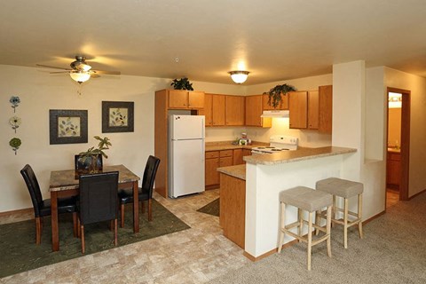 a kitchen with a dining table and a refrigerator