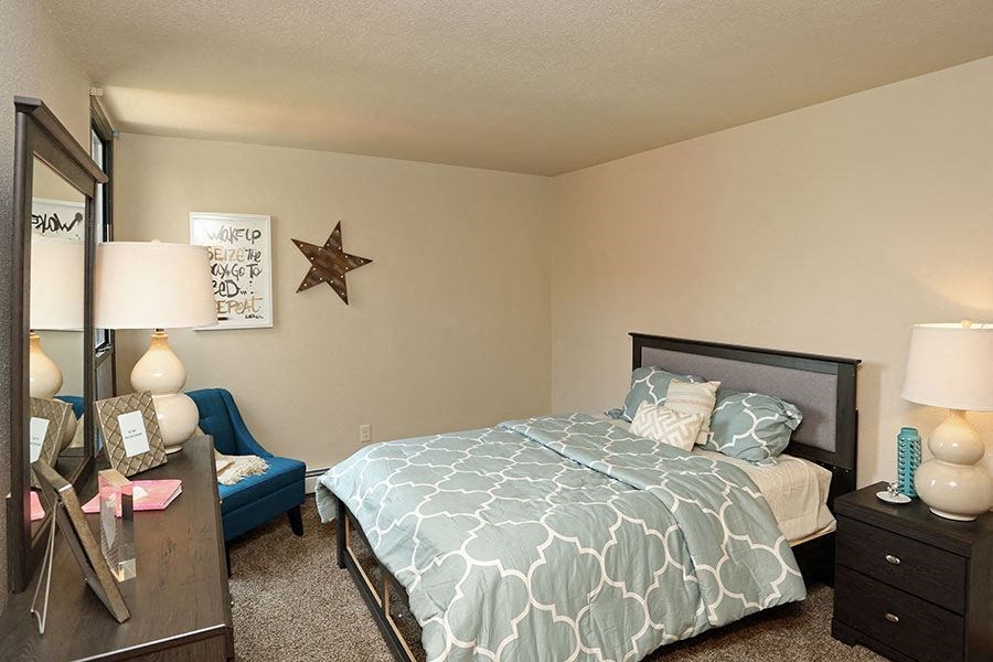 a bedroom with a bed and a chair