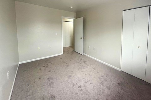 A room with a carpeted floor and white walls.