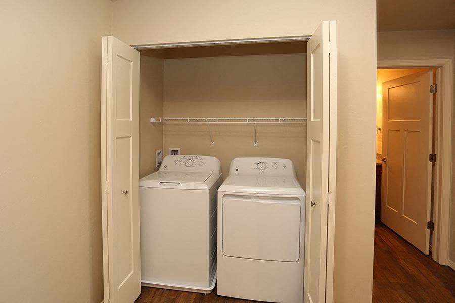 a room with two washes and a dryer in it