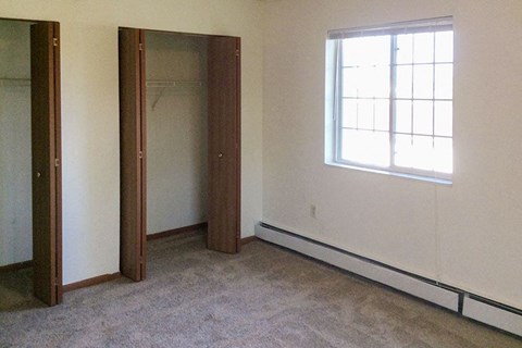 an empty room with a window and a door