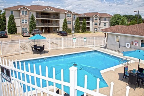 a swimming pool with a white fence around it