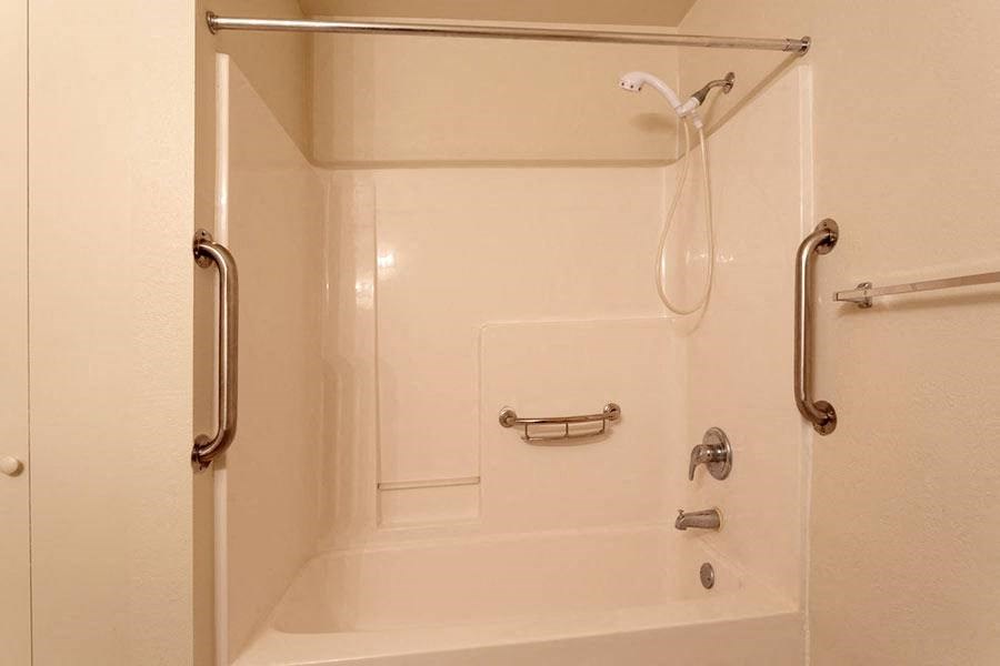 a bathroom with a shower and a bath tub