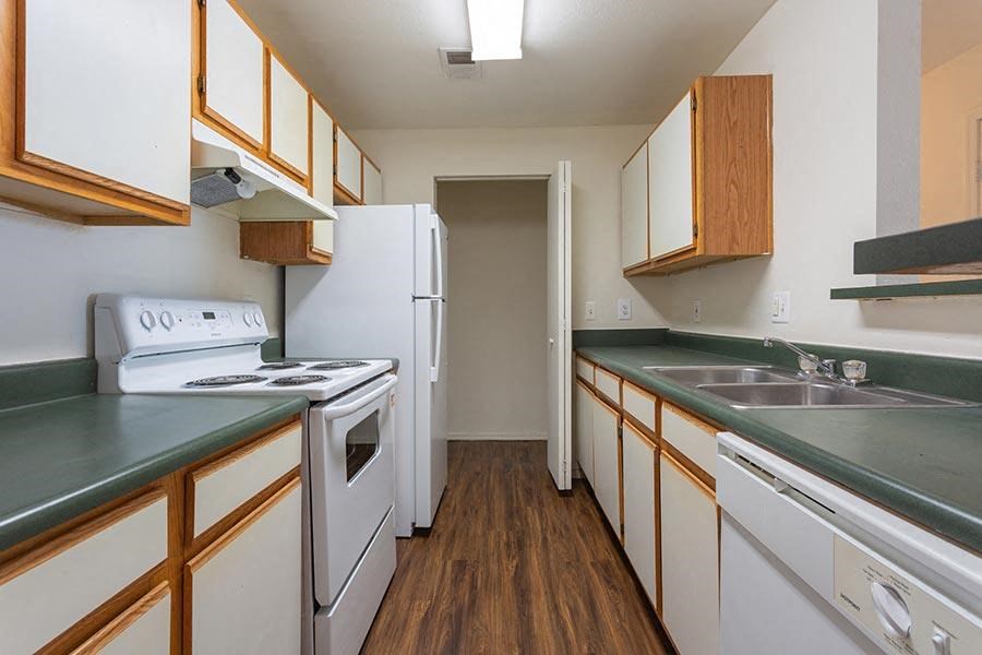 a kitchen with white appliances and green counter tops