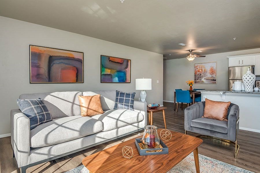 A living room with a grey couch and a wooden coffee table.